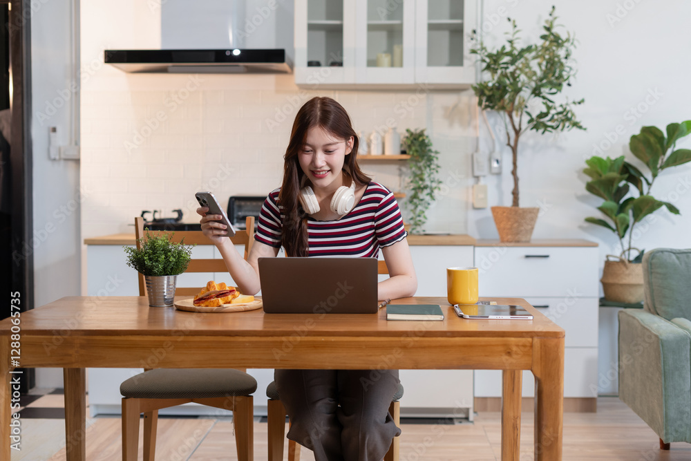 Lifestyle people, using computer working online, doing searching, sitting in the kitchen. Lifestyle people, using computer working online, doing searching, sitting in the kitchen.