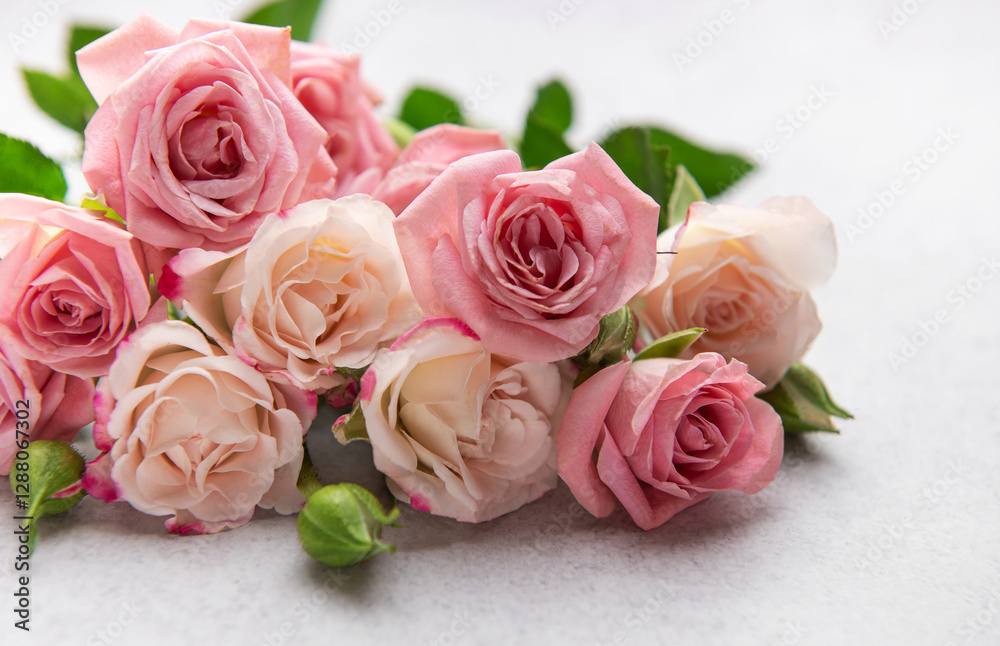 Delicate pink and peach roses forming a beautiful bouquet on a textured surface Delicate pink and peach roses forming a beautiful bouquet on a textured surface