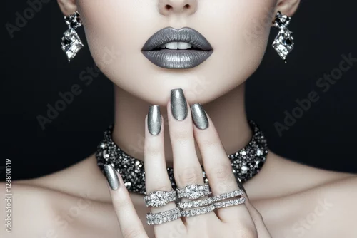 Fototapeta samoprzylepna A close-up of a woman's hands adorned with jewelry rings showcases beauty and fashion, highlighting makeup and manicure