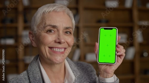 Smiling Senior Woman Holding Smartphone with Green Screen