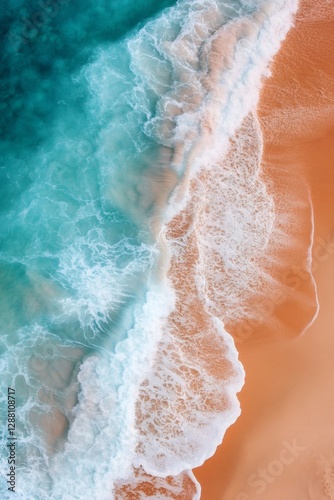 Turquoise ocean waves crashing on golden sandy beach aerial view