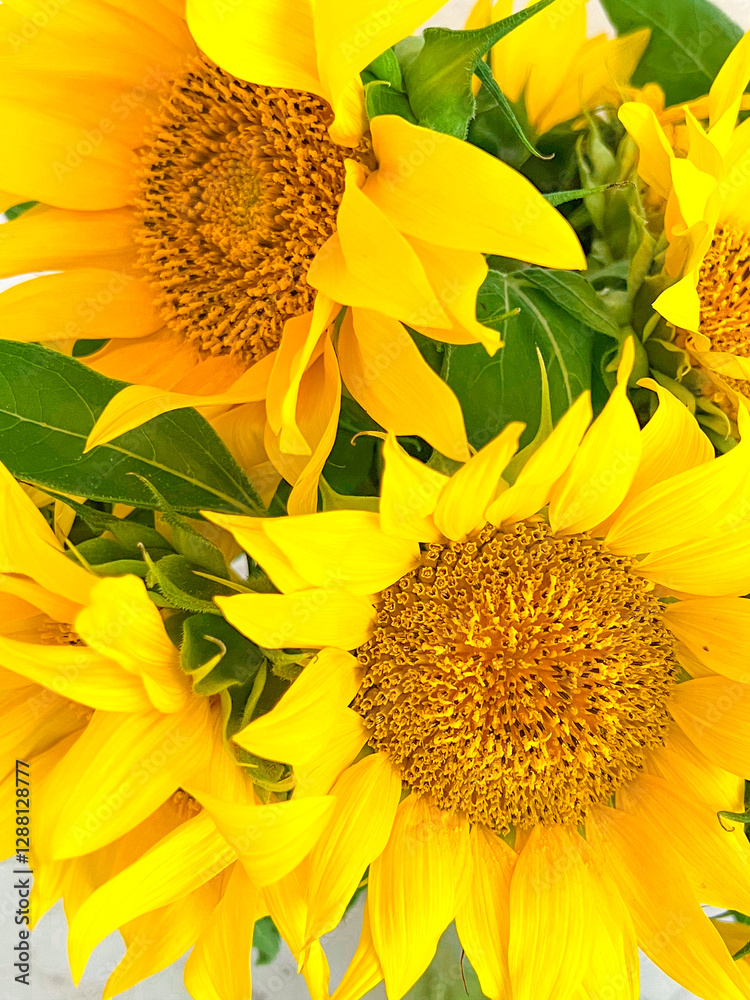 A bouquet of sunflowers is close. Vertical photography. Yellow color