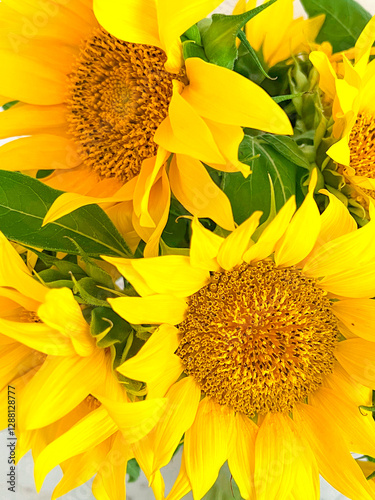 A bouquet of sunflowers is close. Vertical photography. Yellow color