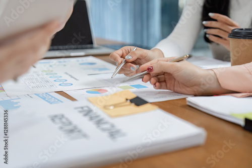 Wallpaper Mural Diverse office workers collaborating on financial reports and strategy planning at a modern workspace. Torontodigital.ca