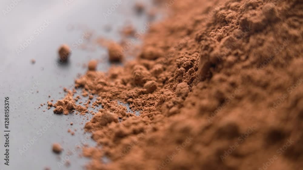 Instant cocoa powder particles falling in slow motion. Aromatic drink soluble ingredient. Macro shot. Rotation Instant cocoa powder particles falling in slow motion. Aromatic drink soluble ingredient. Macro shot. Rotation