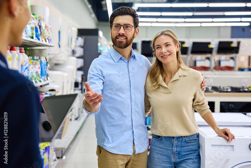 Quadro em tela A couple actively engaging and negotiating with a salesperson in an electronics