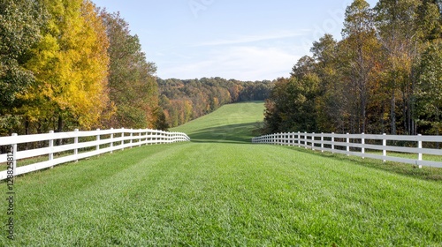Autumnal pasture, rolling hills, white fence, idyllic scene