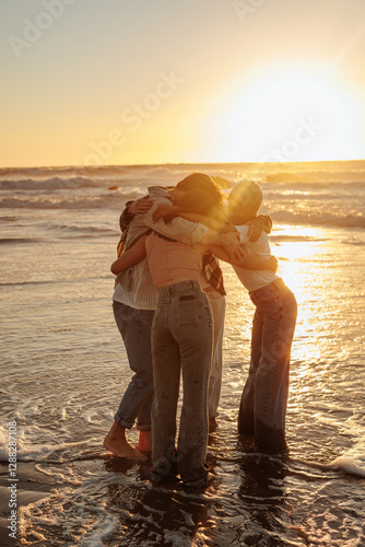 Friends embracing at sunset on beach: sharing a tender moment of togetherness