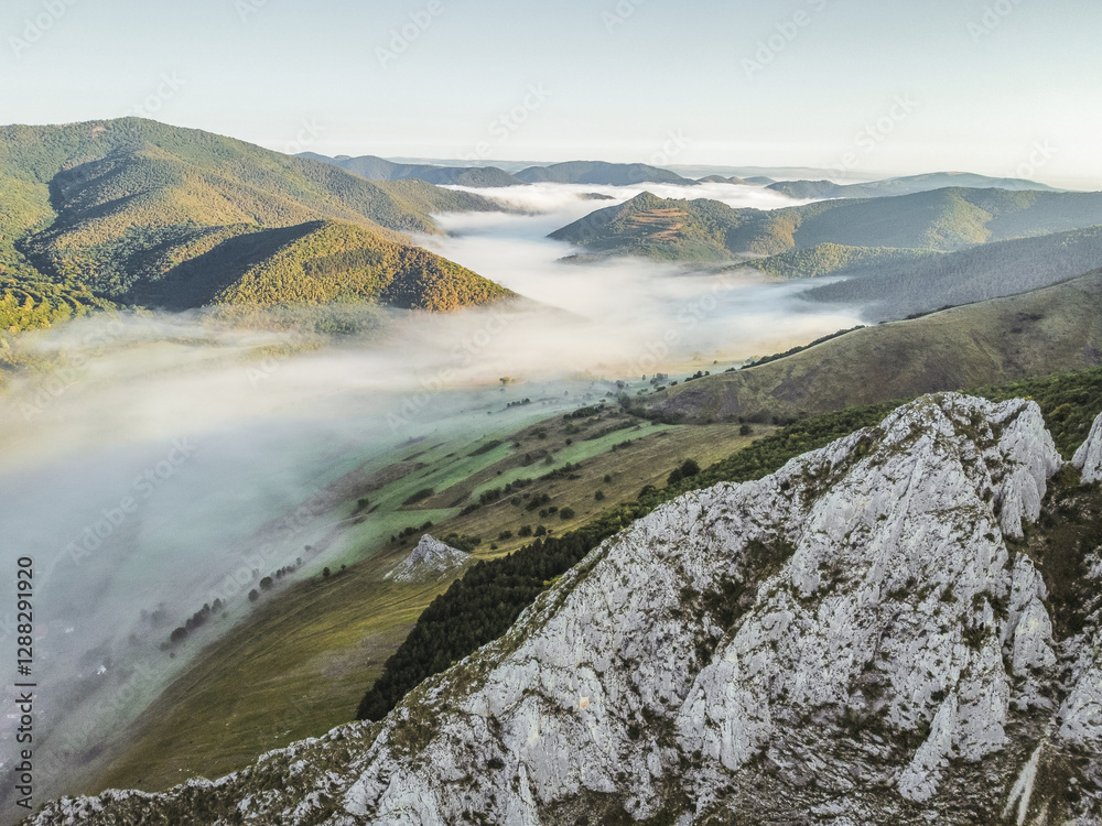 Misty Morning in the Romanian Mountains – Aerial View of Foggy Hills and Rocky Cliffs Misty Morning in the Romanian Mountains – Aerial View of Foggy Hills and Rocky Cliffs