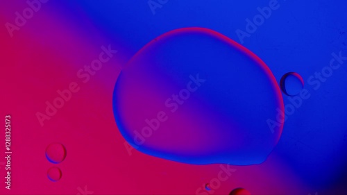 a large drop absorbs several smaller drops on a blue-red gradient background. High resolution footage 4k.
