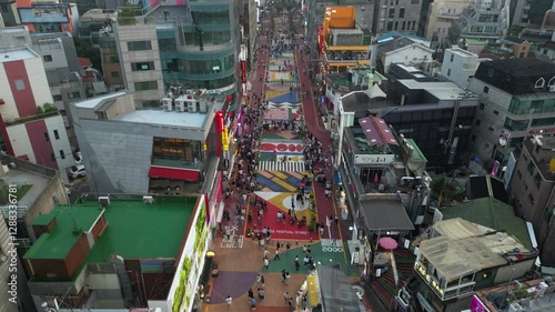 Pull-back aerial footage of the people walking on the Hongdae Street in Seoul, South Korea