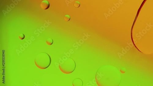a large drop connects to a smaller drop on a yellow-green gradient background. High resolution footage 4k.