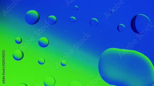 medical needle releases a drop and connects with another drop on a blue-green gradient background. 4K high definition video.