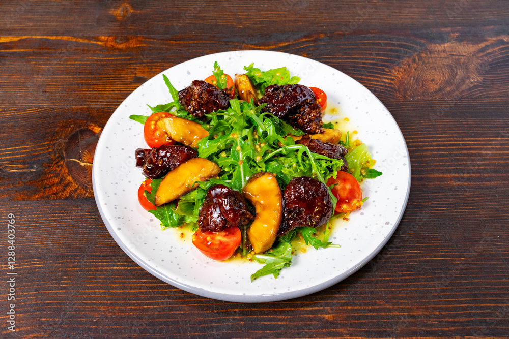 Fresh salad with cherry tomatoes and glazed fruits on a plate Fresh salad with cherry tomatoes and glazed fruits on a plate