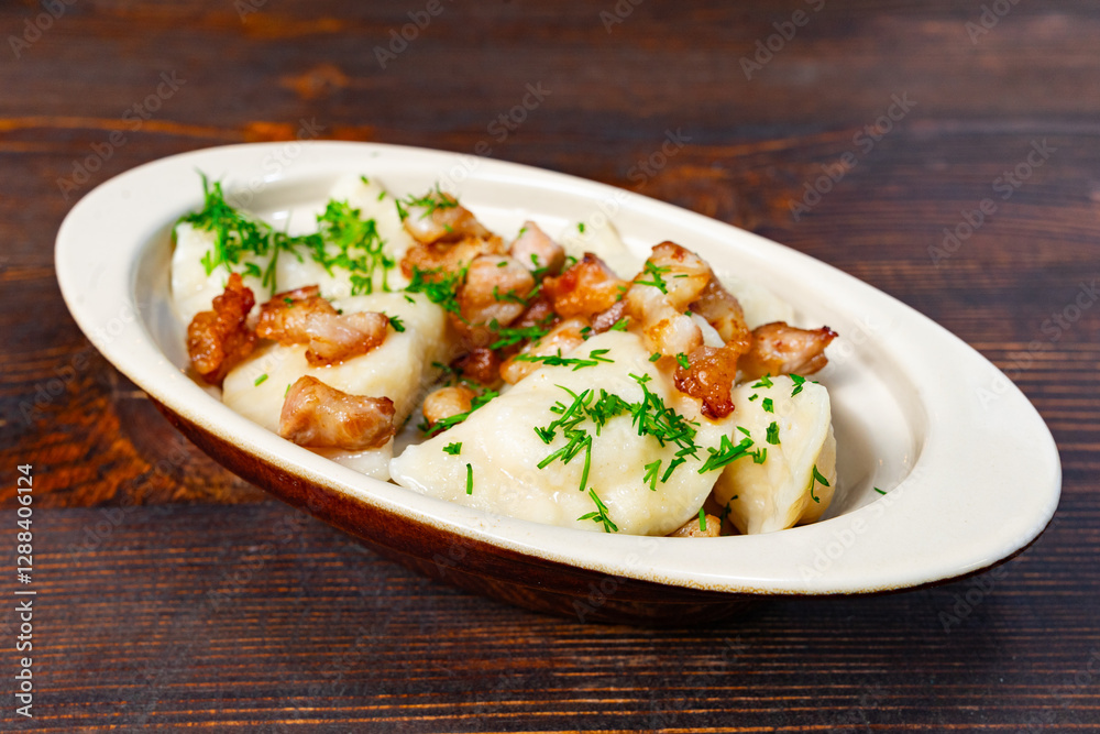 Delicious potato dumplings served with crispy bacon bits Delicious potato dumplings served with crispy bacon bits