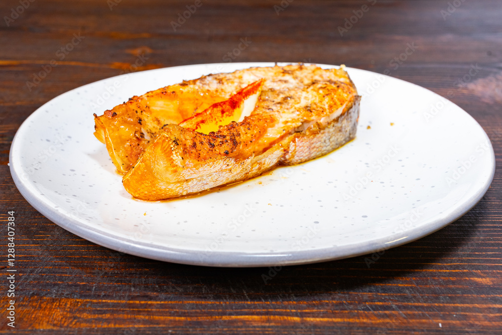 Delicious grilled salmon fillet served on a white plate Delicious grilled salmon fillet served on a white plate