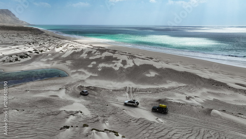 Exploring the unique landscapes of Socotra Island with vehicles on sandy shores