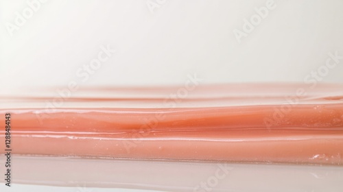Smooth, translucent layers exhibit subtle peach tones, creating