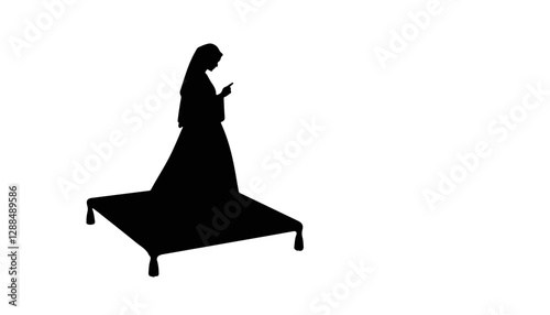Silhouette of woman standing on carpet and looking at phone