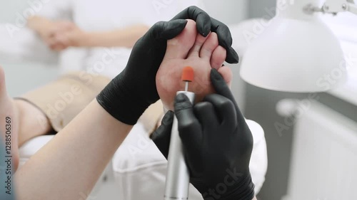 Close Up shot of a foot treatment or Foot pedicuring with a professional machine in salon or in a clinic.