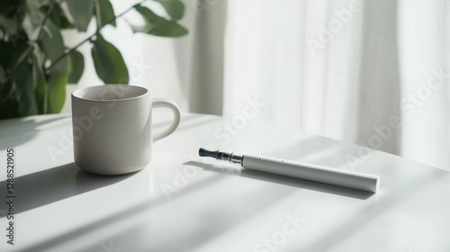 Vaping device on a smooth white table next to a ceramic mug. Featuring sleek minimalism and peaceful design