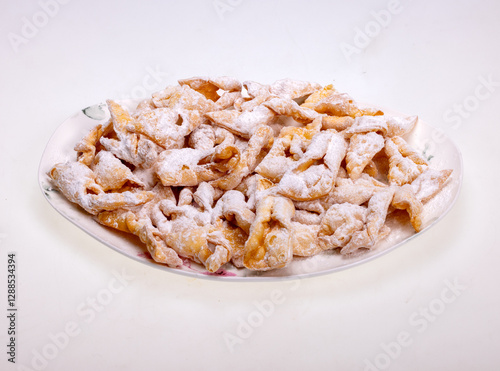 Angel wings (Faworki), cakes. Sweet pastry deep fried and sprinkled with powdered sugar photo