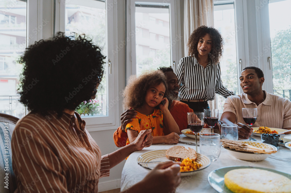 Storytelling image of a Family reunited at parents house for lunch on the holidays. Family members celebrating at home eating good food, sharing love and positive emotions. Storytelling image of a Family reunited at parents house for lunch on the holidays. Family members celebrating at home eating good food, sharing love and positive emotions.