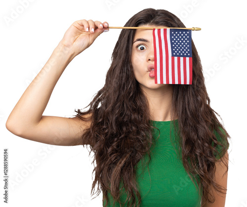A young happy girl with a smile on her face holds an American flag in her hands. Symbol of patriotism and freedom.
