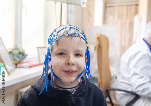 A boy's brain is examined on an EEG machine. Electroencephalogram is performed in a hospital laboratory to detect neurological diseases. Encephalogram for children