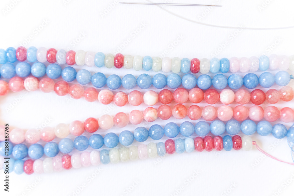 Preparing gemstone jewelry. Natural stones , needle, elastic silicone. Craft, handmade conception. Free space for text.