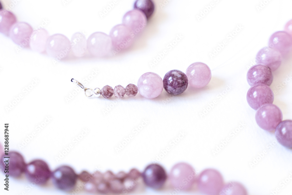 Preparing gemstone jewelry. Natural stones pink quartz, Amethyst, silver. Craft, handmade conception. Free space for text.