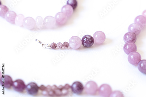 Obraz na płótnie Preparing gemstone jewelry. Natural stones pink quartz, Amethyst, silver. Craft, handmade conception. Free space for text. w salonie