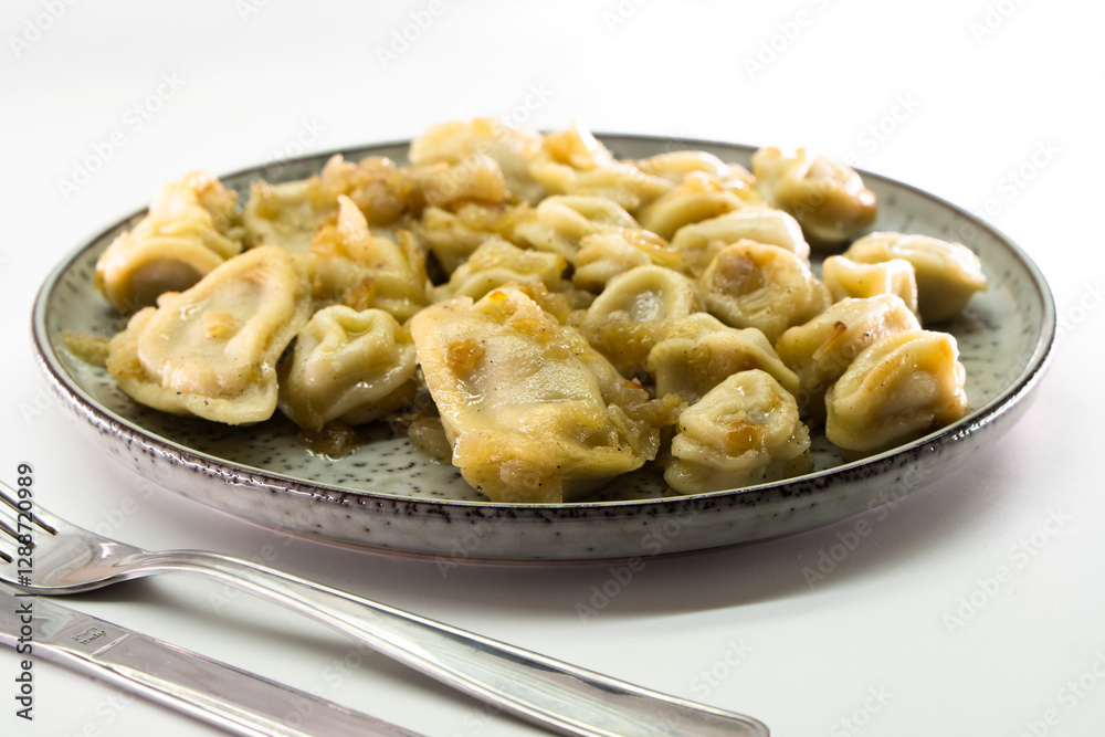 Homemade dumplings with fried onions on white background. Food concept Homemade dumplings with fried onions on white background. Food concept