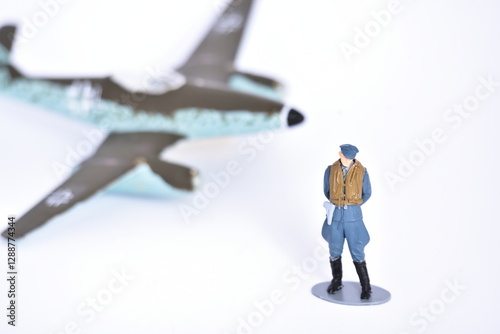 Handmade plastic toy, assembled, glued and painted. German pilot from World War 2 and Messerschmitt 262 in the background.