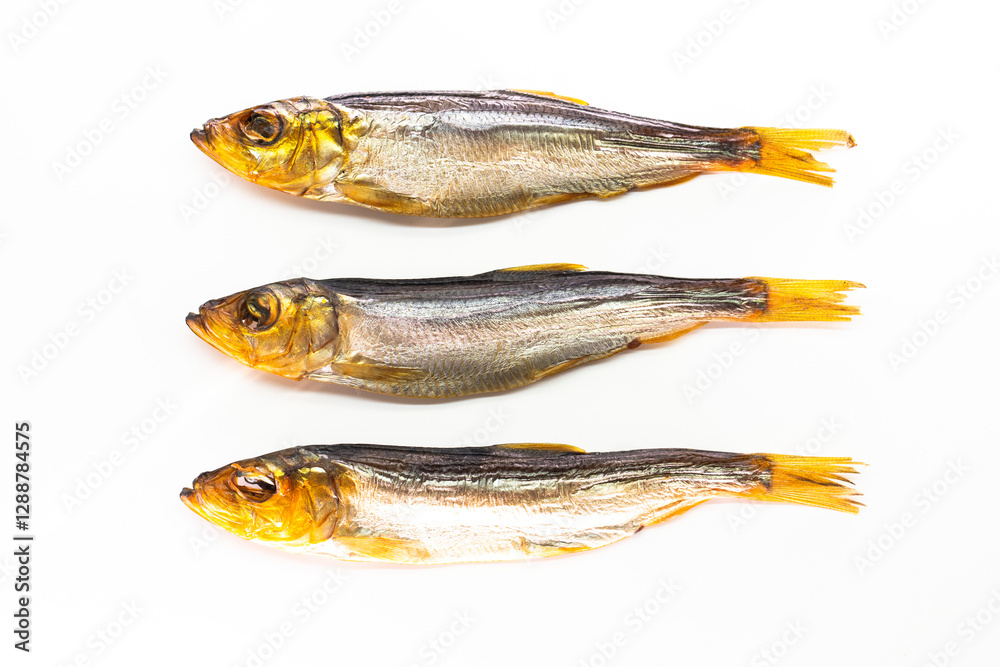 Hot smoked whole herrings on kitchen table. smoked fish isolated on white Hot smoked whole herrings on kitchen table. smoked fish isolated on white