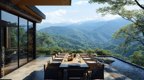 A luxurious outdoor dining area on a mountain terrace, with sweeping views of the lush green valleys and snow-capped peaks. photo