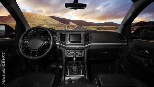 Фотография A black car with a large dashboard and a sunroof