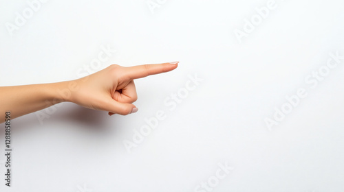 A female hand pointing to the right side with her index finger. White background. Close up hand shot. 