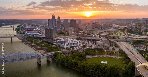 Cincinnati city in state of Ohio with brightly illuminated high skyscraper buildings in downtown district. American megapolis with business financial district at sunset