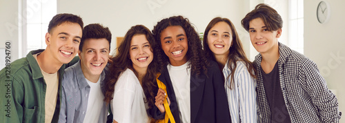 Fotografie Portrait of a group of happy smiling diverse high school students and classmates in casual clothes standing together in a row and looking cheerful and positively at camera