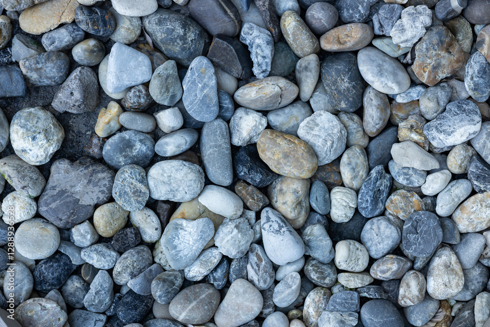 Close-up of a pebble-patterned walkway surface. Close-up of a pebble-patterned walkway surface.
