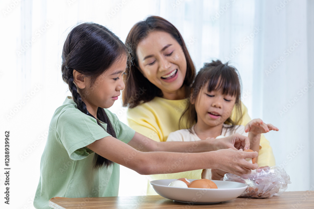 Happy family, father, mother and daughter are having fun peeling eggs in the living room Happy family, father, mother and daughter are having fun peeling eggs in the living room