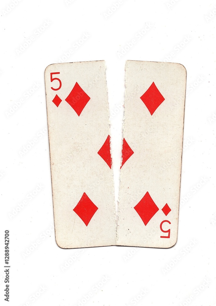 Obraz premium A vintage playing card torn in half from top to bottom on a white background.