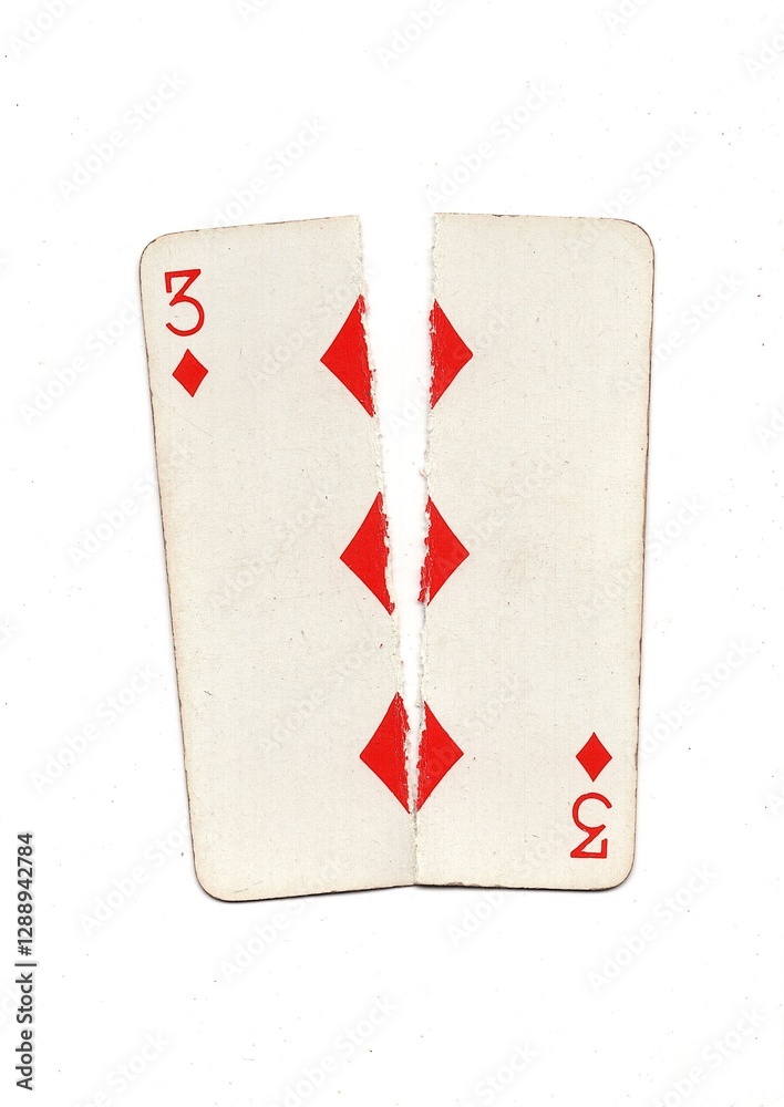 Obraz premium A vintage playing card torn in half from top to bottom on a white background.