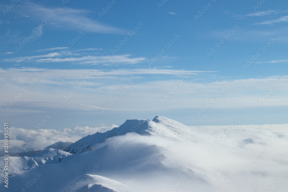 Snow-Covered Mountain Peaks Above the Clouds Snow-Covered Mountain Peaks Above the Clouds