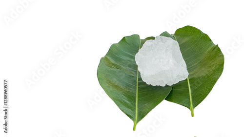 Crystal clear alum cubes or Potassium alum in on green leaves chemical compound substance concept for beauty spa and underarm treatment industrial