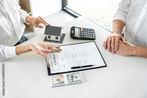 Real estate agent Sales manager holding filing keys to customer after signing rental lease contract of sale purchase agreement, concerning mortgage loan offer for and house insurance