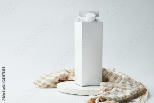 White Carton Milk Packaging on a Minimalist Setting With a Neutral Background and Checkered Cloth