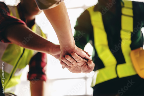 A group of construction workers are shaking hands