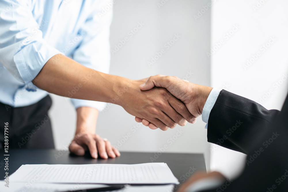 Two men shake hands in a business meeting Two men shake hands in a business meeting